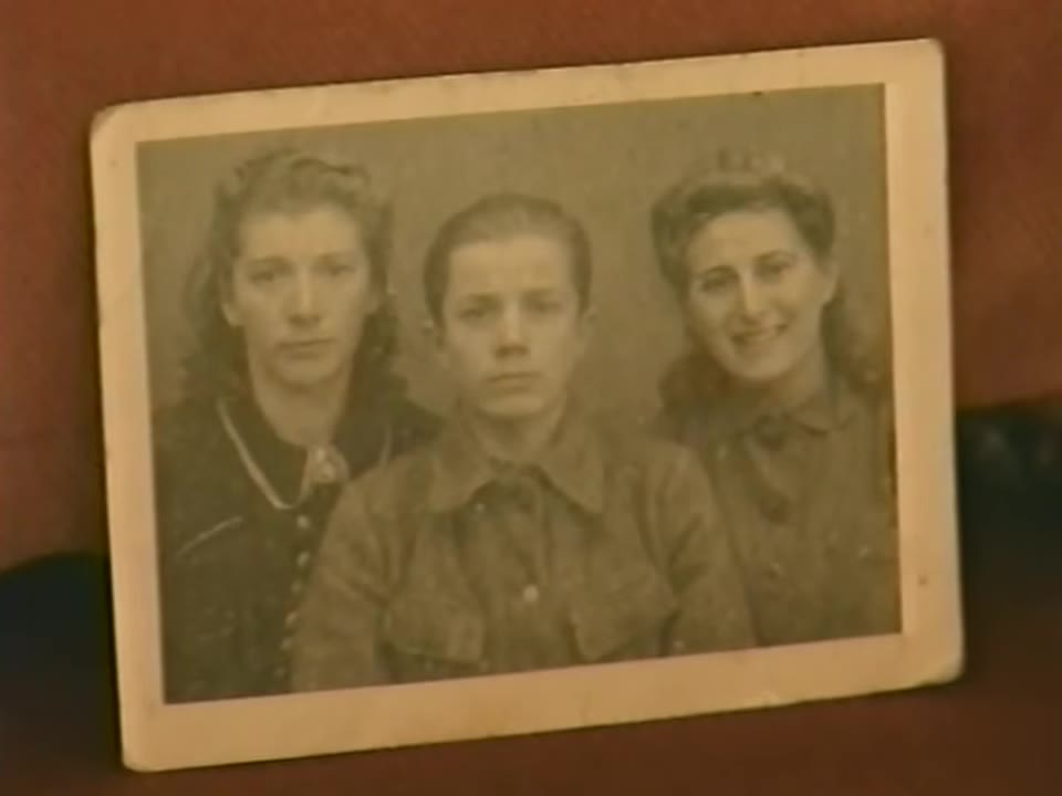 A worn photograph of three young people: a young woman, a boy, and Ida